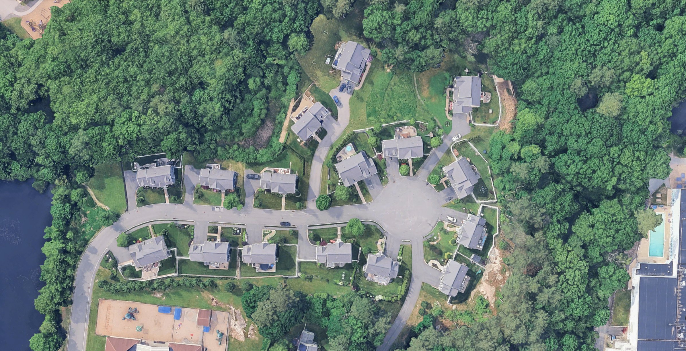 Satellite view of Pond View Lane — sixteen homes around one cul-de-sac, wrapped by wooded open space, with Kelleher Pond at lower left